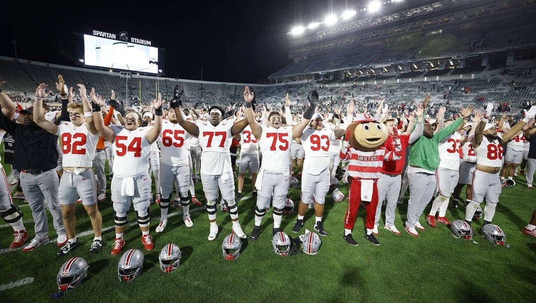 Ohio State players celebrate and sing after defeating Michigan State in an NCAA college football game, Saturday, Sept. 28, 2024, in East Lansing, Mich.