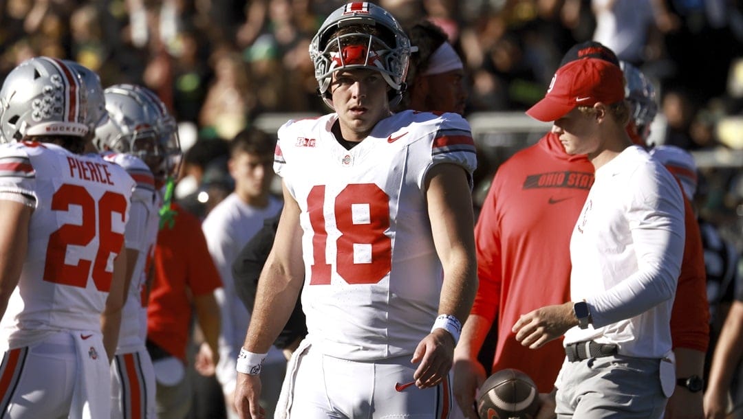 Ohio State quarterback Will Howard warms up before an NCAA college football game against Oregon, Saturday, Oct. 12, 2024, in Eugene, Ore.