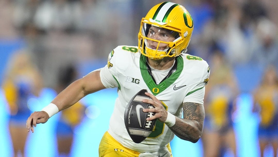 Oregon quarterback Dillon Gabriel (8) rolls out uring the second half of an NCAA college football game against UCLA Saturday, Sept. 28, 2024, in Pasadena, Calif.