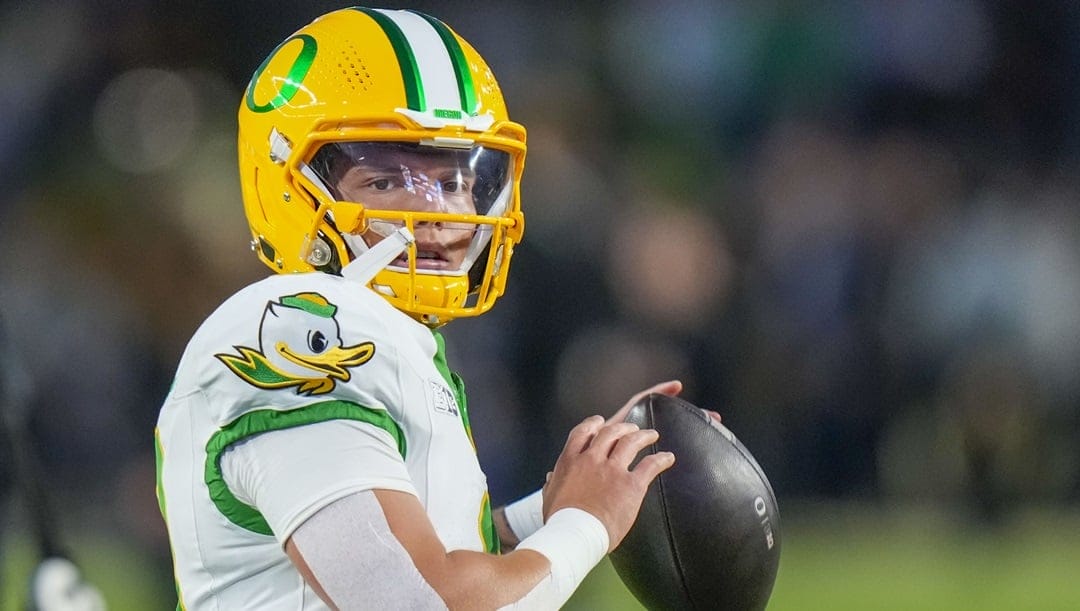 Oregon quarterback Dillon Gabriel looks to throw during warmups before playing Purdue in an NCAA college football game in West Lafayette, Ind., Friday, Oct. 18, 2024.