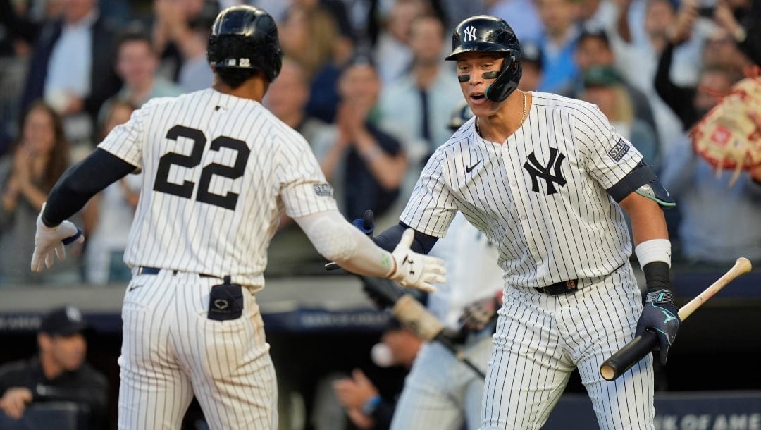 New York Yankees' Juan Soto (22), left, celebrates his solo home run with Aaron Judge, right, during the first inning of a baseball game against the Cleveland Guardians at Yankee Stadium Tuesday, Aug. 20, 2024, in New York.