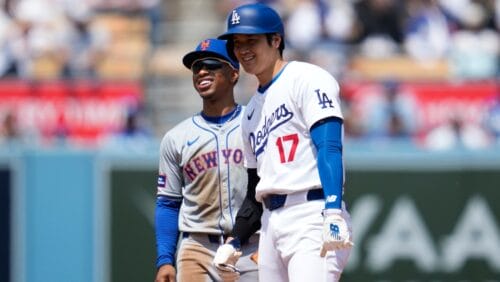 Los Angeles Dodgers designated hitter Shohei Ohtani (17) laughs with New York Mets shortstop Francisco Lindor (12) on second base during the first inning of a baseball game in Los Angeles, Saturday, April 20, 2024.