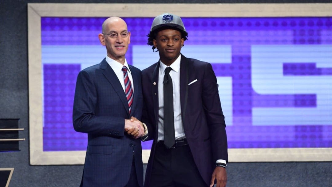 BROOKLYN, NY - JUNE 22: De'Aaron Fox smiles with Adam Silver after being selected fifth overall by the Sacramento Kings in the 2017 NBA Draft on June 22, 2017 at Barclays Center in Brooklyn, New York. NOTE TO USER: User expressly acknowledges and agrees that, by downloading and or using this photograph, User is consenting to the terms and conditions of the Getty Images License Agreement. Mandatory Copyright Notice: Copyright 2017 NBAE (Photo by Jesse D. Garrabrant/NBAE via Getty Images)