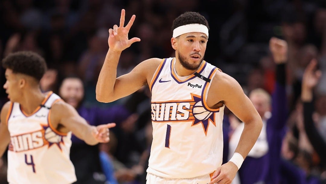 PHOENIX, ARIZONA - OCTOBER 17: Devin Booker #1 of the Phoenix Suns reacts to a three-point shot against the Los Angeles Lakers during the first half of the preseason NBA game at Footprint Center on October 17, 2024 in Phoenix, Arizona. NOTE TO USER: User expressly acknowledges and agrees that, by downloading and/or using this photograph, user is consenting to the terms and conditions of the Getty Images License Agreement.