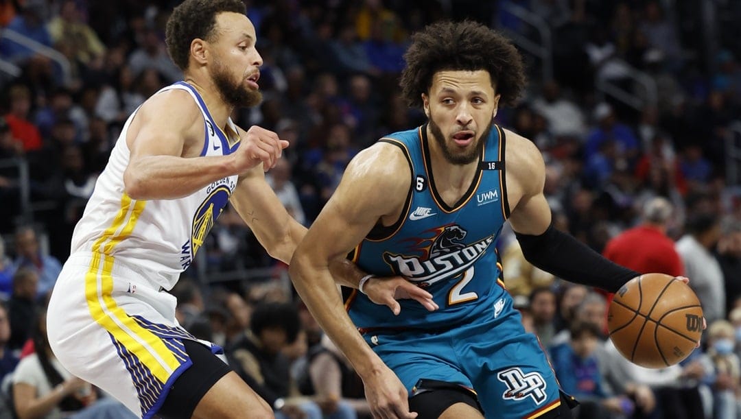 Cade Cunningham #2 of the Detroit Pistons dribbles on Stephen Curry #30 of the Golden State Warriors in the second half of the game at Little Caesars Arena on October 30, 2022 in Detroit, Michigan.