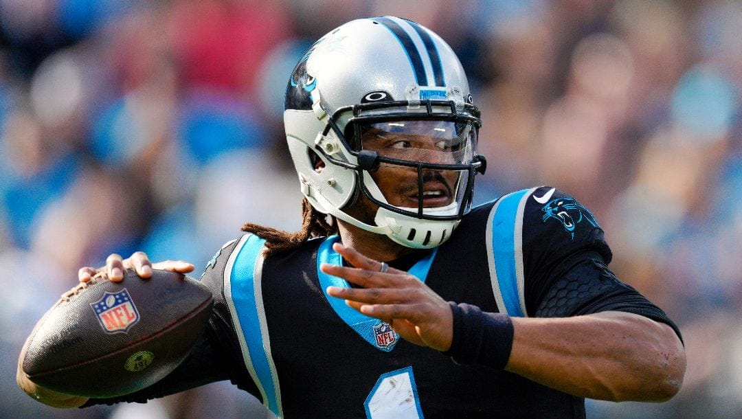 Carolina Panthers quarterback Cam Newton passes against the Tampa Bay Buccaneers during the first half of an NFL football game on Dec. 26, 2021, in Charlotte, N.C. Newton is looking for another shot. The 2015 NFL Most Valuable Player announced on social media that he’ll be working out for pro scouts at Auburn’s Pro Day on Tuesday, March 21, 2023.