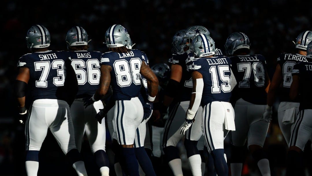 Dallas Cowboys break the offensive huddle as a group including lineman Tyler Smith (73) T.J. Bass (66) wide receiver CeeDee Lamb (88) Jalen Tolbert (1) running back Ezekiel Elliott (15) during an NFL football game against the Detroit Lions on Sunday, Oct. 13, 2024, in Arlington, Texas. (AP Photo/Matt Patterson)