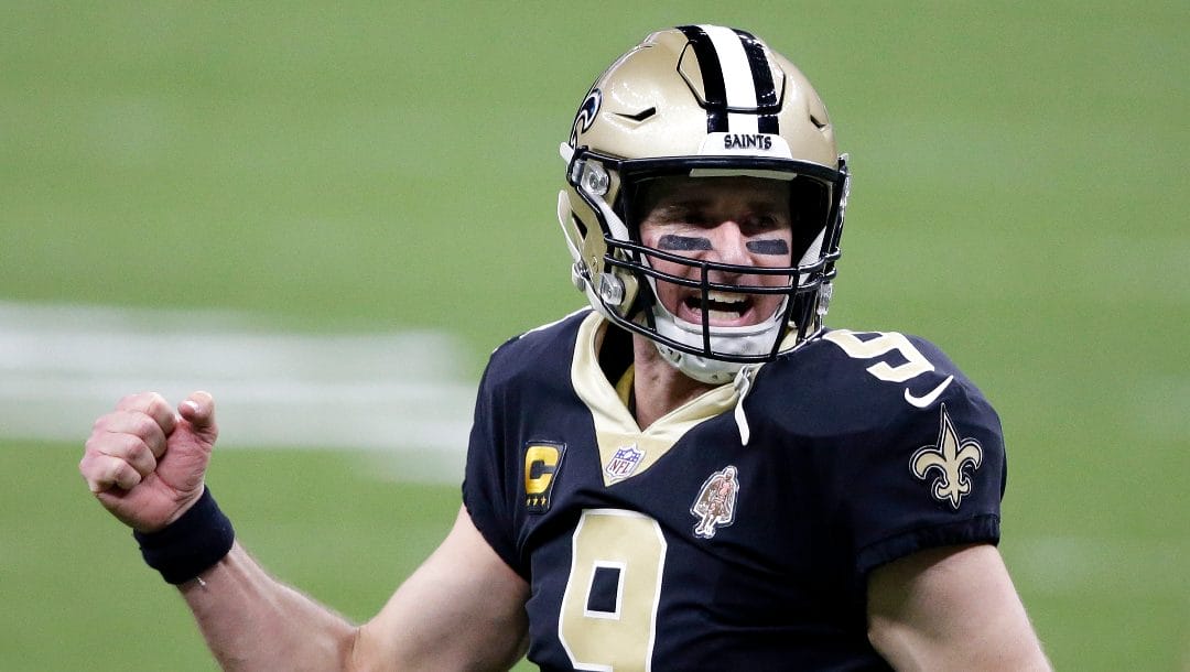 New Orleans Saints quarterback Drew Brees (9) reacts after a touchdown by Alvin Kamara in the second half of an NFL wild-card playoff football game against the Chicago Bears in New Orleans, Sunday, Jan. 10, 2021. Former Purdue quarterback Drew Brees is returning to his alma mater as a coach for the Jan. 2 Citrus Bowl game against No. 17 LSU.  The retired NFL star will join new Purdue coach Ryan Walters as he settles into his new job.