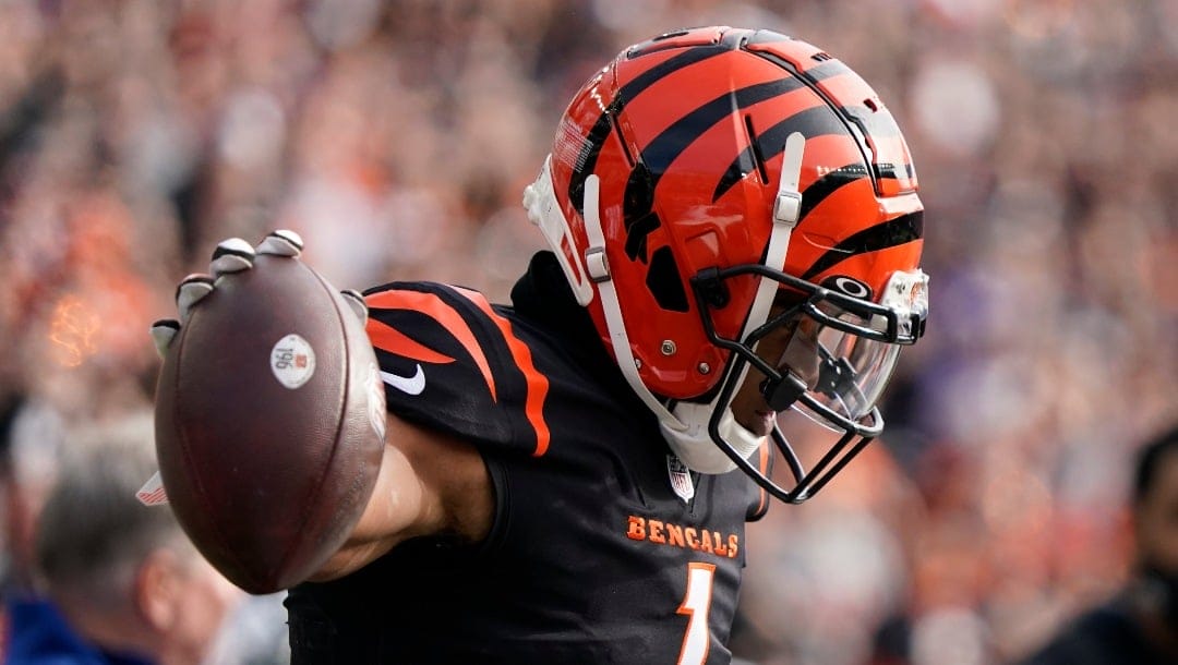 Cincinnati Bengals' Ja'Marr Chase (1) reacts after a catch during the first half of an NFL football game against the Baltimore Ravens, Sunday, Dec. 26, 2021, in Cincinnati. (AP Photo/Jeff Dean)