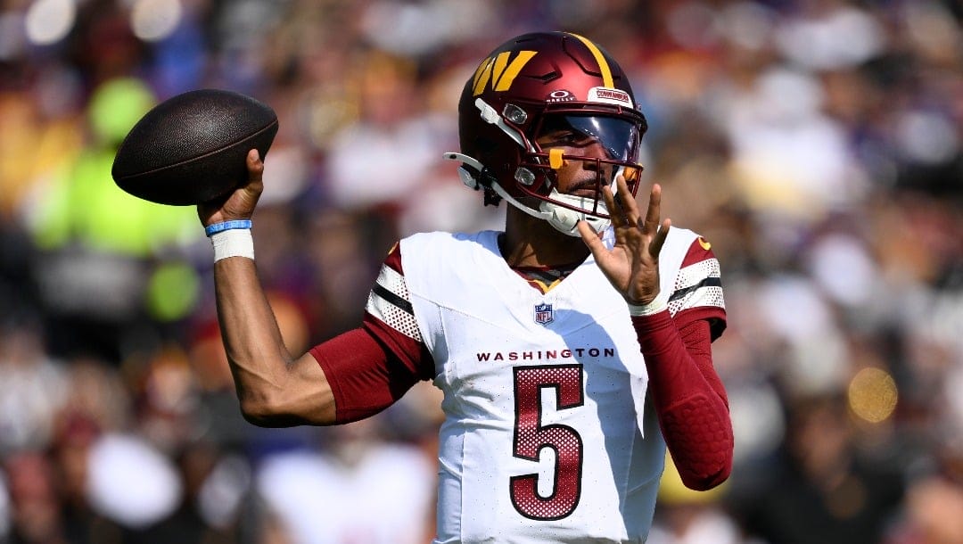 Washington Commanders quarterback Jayden Daniels (5) in action during the first half of an NFL football game against the Baltimore Ravens, Sunday, Oct. 13, 2024, in Baltimore. (AP Photo/Nick Wass)