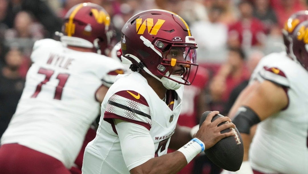 Washington Commanders quarterback Jayden Daniels (5) during the first half of an NFL football game against the Arizona Cardinals, Sunday, Sept. 29, 2024, in Glendale, Ariz. (AP Photo/Rick Scuteri)