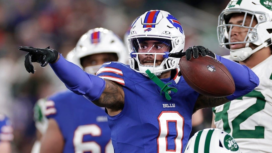 Buffalo Bills wide receiver Keon Coleman (0) reacts after converting a first down next to New York Jets defensive tackle Leki Fotu, right, and cornerback Brandin Echols, bottom, during the second half of an NFL football game in East Rutherford, N.J., Monday, Oct. 14, 2024. (AP Photo/Adam Hunger)