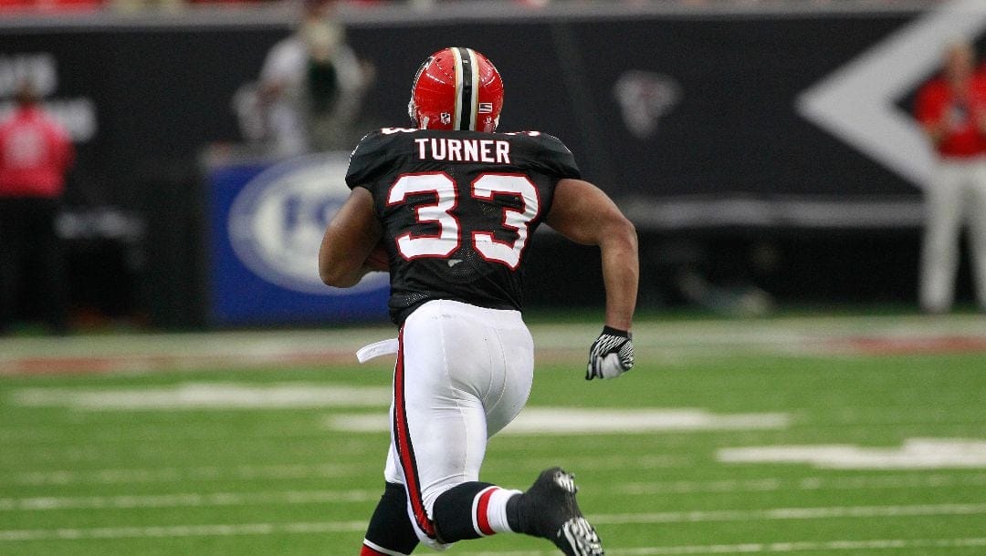 Atlanta Falcons running back Michael Turner (33) runs up field against the Carolina Panthers during the first half of an NFL football game Sunday, Oct. 16, 2011, in Atlanta.