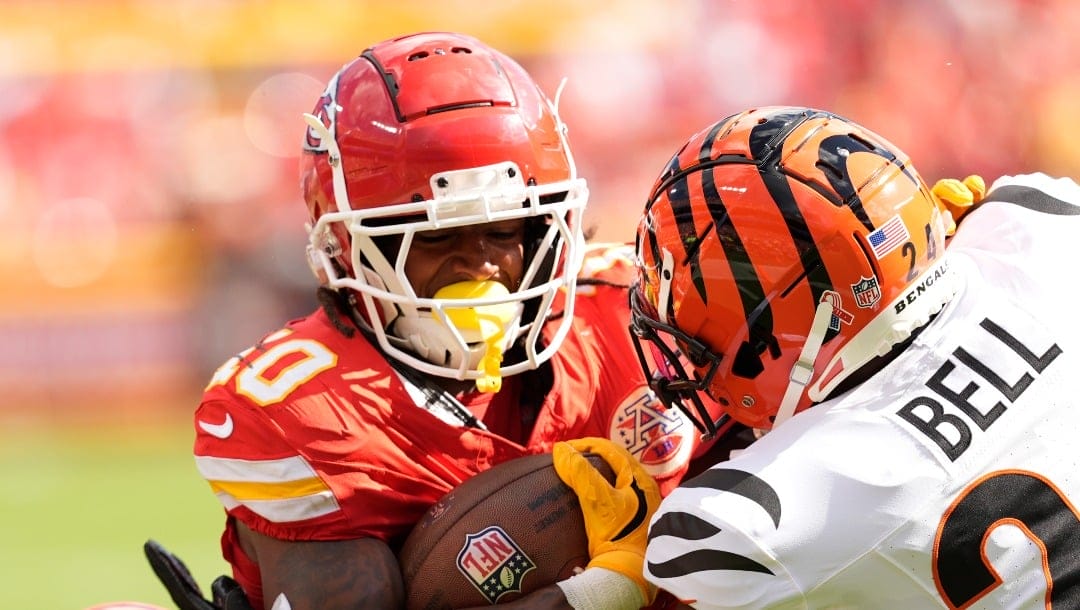 Kansas City Chiefs running back Isiah Pacheco (10) is stopped by Cincinnati Bengals safety Vonn Bell (24) during the first half of an NFL football game Sunday, Sept. 15, 2024, in Kansas City, Mo. (AP Photo/Charlie Riedel)