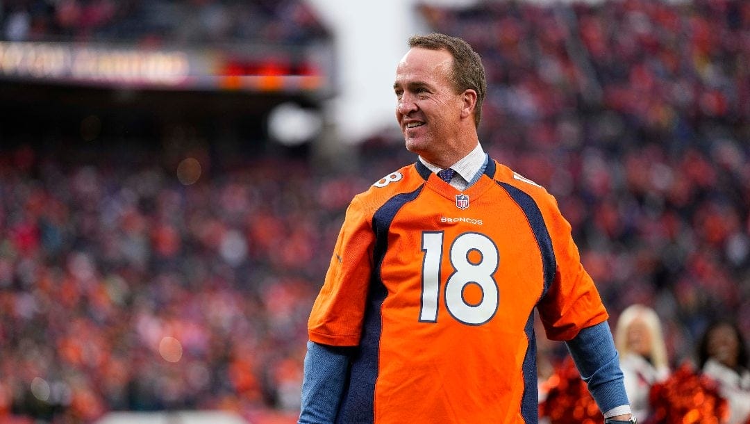 Peyton Manning looks smiles at his Ring of Fame induction ceremony during an NFL football game between the Denver Broncos and the Washington Football Team Sunday, Oct. 31, 2021, in Denver.