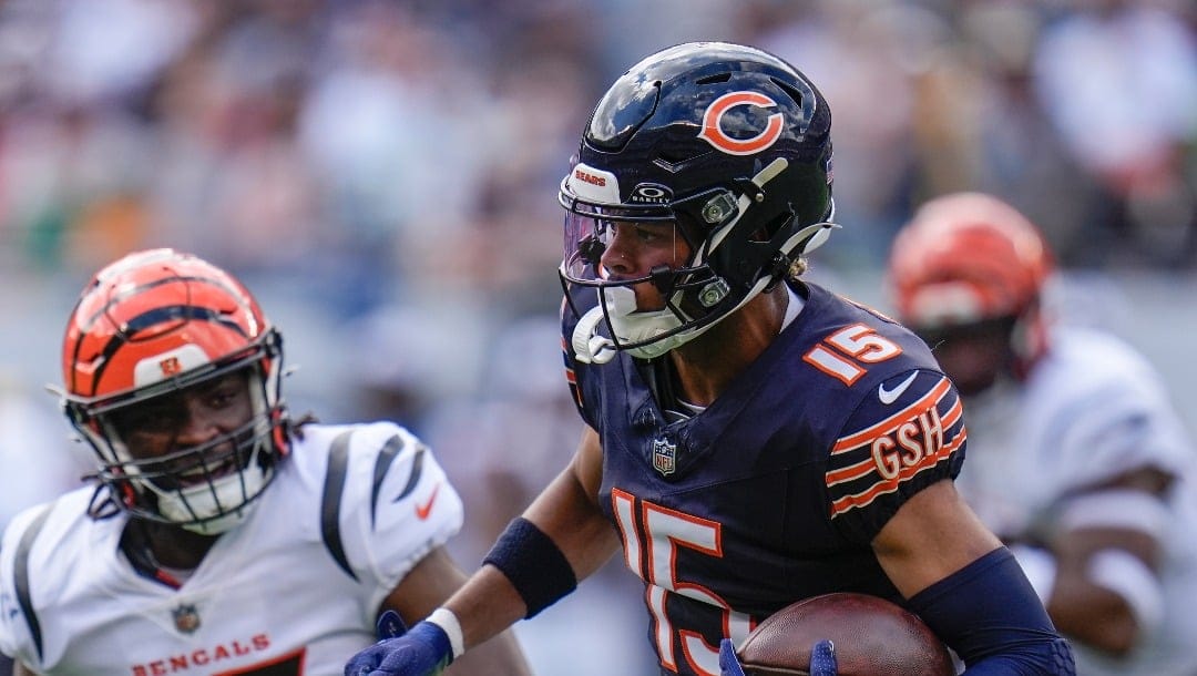 Chicago Bears wide receiver Rome Odunze (15) runs with the ball against Cincinnati Bengals linebacker Maema Njongmeta (45) during the first half of an NFL preseason football game, Saturday, Aug. 17, 2024, at Soldier Field in Chicago. (AP Photo/Erin Hooley)