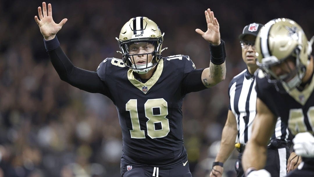 New Orleans Saints quarterback Spencer Rattler (18) celebrates after throwing a touchdown pass during an NFL football game against the Tampa Bay Buccaneers, Sunday, Oct. 13, 2024, in New Orleans.