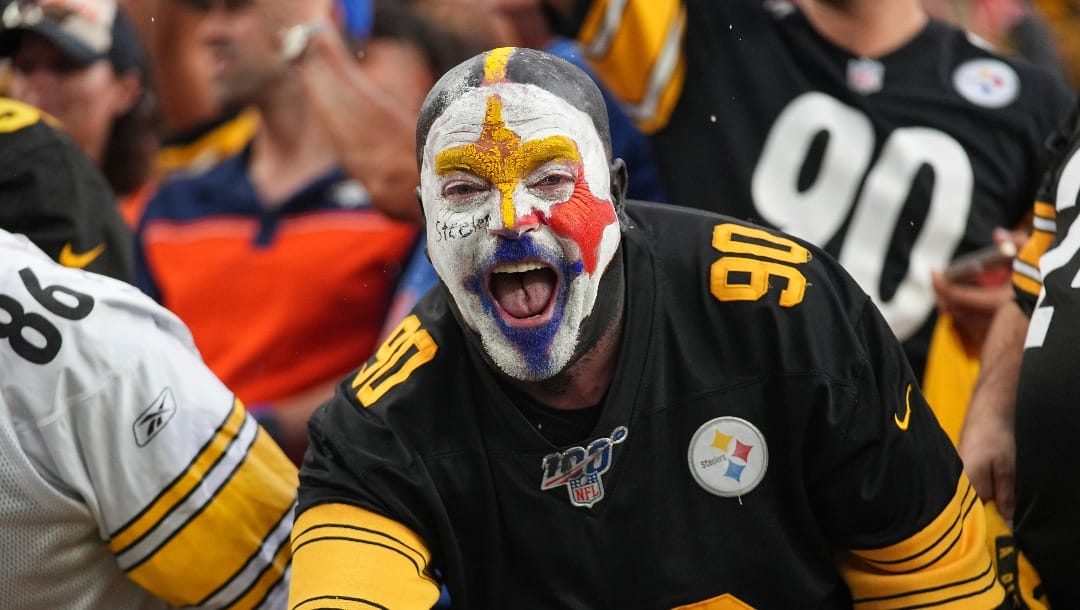 Pittsburgh Steelers fan cheers while taking on the Denver Broncos in an NFL football game, Sunday, Sept. 15, 2024, in Denver. (AP Photo/Bart Young)