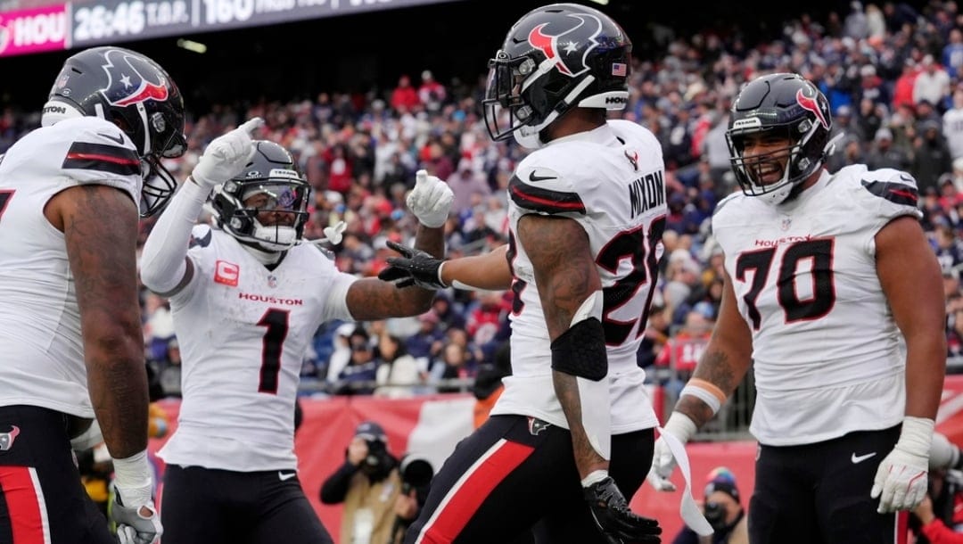 Houston Texans running back Joe Mixon (28) celebrates after his touchdown with wide receiver Stefon Diggs (1) and center Juice Scruggs (70) during the second half of an NFL football game against the New England Patriots, Sunday, Oct. 13, 2024, in Foxborough, Mass.