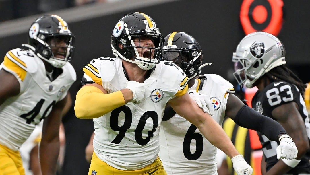 Pittsburgh Steelers linebacker T.J. Watt (90) celebrates with linebacker Patrick Queen (6) and linebacker Jeremiah Moon (49) after forcing a fumble, that the Steelers recovered, during the first half of an NFL football game against the Las Vegas Raiders in Las Vegas, Sunday, Oct. 13, 2024. (AP Photo/David Becker)