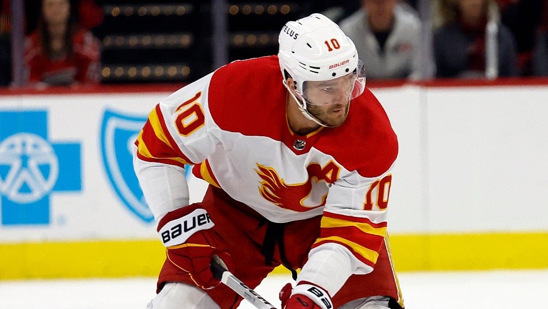 Calgary Flames' Jonathan Huberdeau (10) controls the puck against the Carolina Hurricanes during the first period of an NHL hockey game in Raleigh, N.C., Sunday, March 10, 2024. (AP Photo/Karl B DeBlaker)