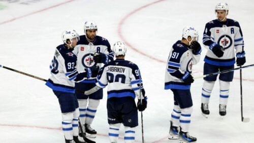 Winnipeg Jets right wing Nikita Chibrikov (90) celebrates with teammates after scoring against the Minnesota Wild during the third period of a preseason NHL hockey game Friday, Sept. 27, 2024, in St. Paul, Minn.