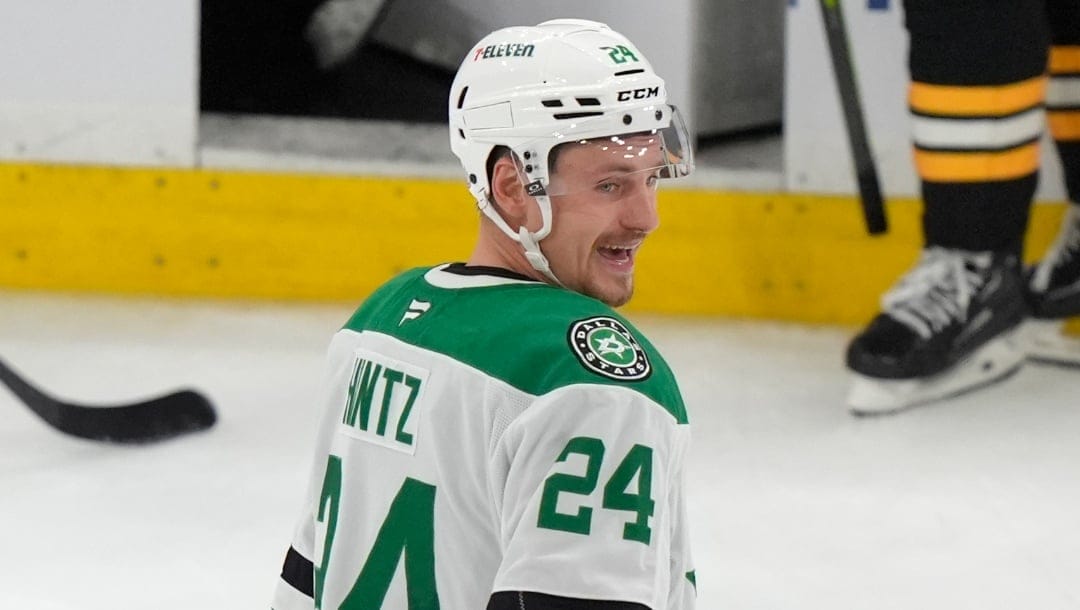 Dallas Stars center Roope Hintz (24) smiles as he returns to the bench after scoring in the third period of an NHL hockey game against the Boston Bruins, Thursday, Oct. 24, 2024, in Boston. (AP Photo/Steven Senne)