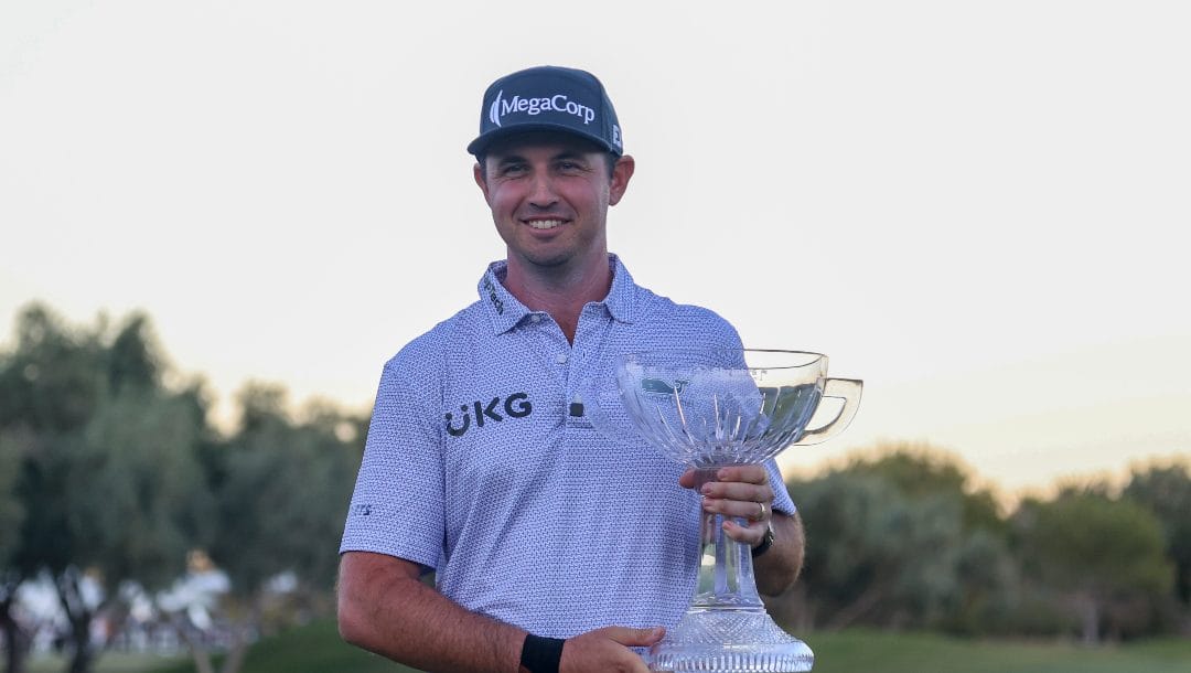 J.T. Poston poses with the trophy after winning the Shriners Children's Open golf tournament, Sunday, Oct. 20, 2024, in Las Vegas.