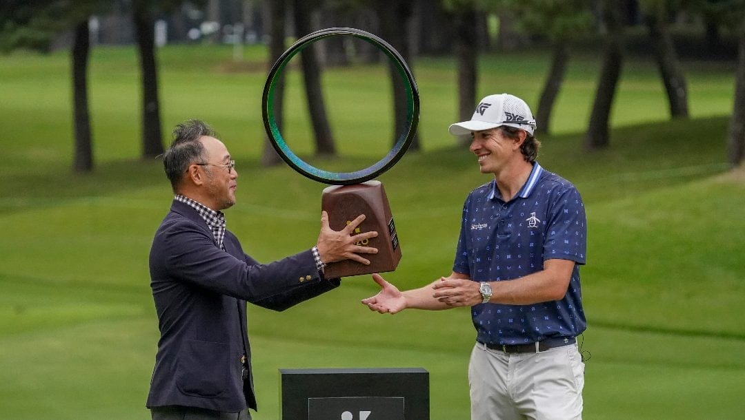 Nico Echavarria of Colombia, right, is presented the trophy by Zozo President and CEO Kotaro Sawada after winning the PGA Tour Zozo Championship at the Narashino Country Club in Inzai on the outskirts of Tokyo, Sunday, Oct. 27, 2024.