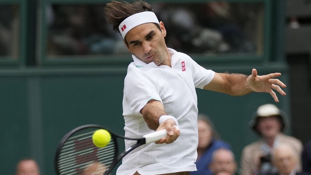 Switzerland's Roger Federer returns the ball to Italy's Lorenzo Sonego on day seven of the Wimbledon Tennis Championships in London, Monday, July 5, 2021. Roger Federer plans to play at his hometown tournament in October when the Swiss Indoors is staged for the first time since 2019, organizers in Basel said Tuesday, April 26, 2022. Federer has not played competitive tennis since undergoing another knee surgery after losing in the Wimbledon quarterfinals last July.