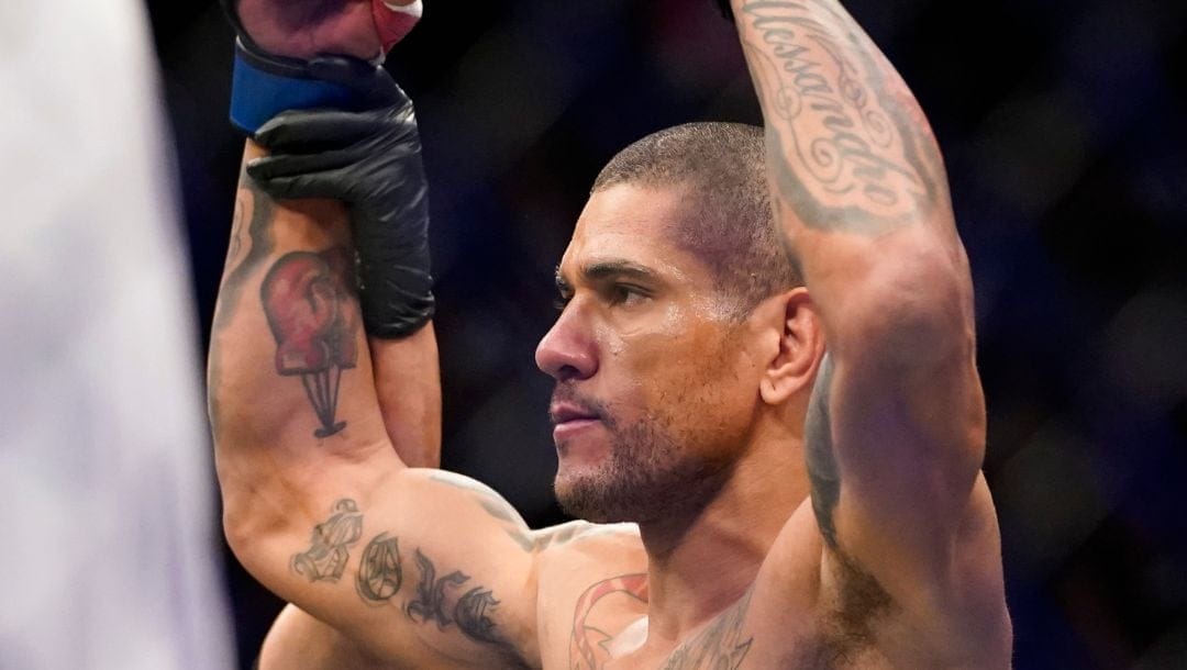 Alex Pereira celebrates after winning a middleweight bout against Sean Strickland during the UFC 276 mixed martial arts event.