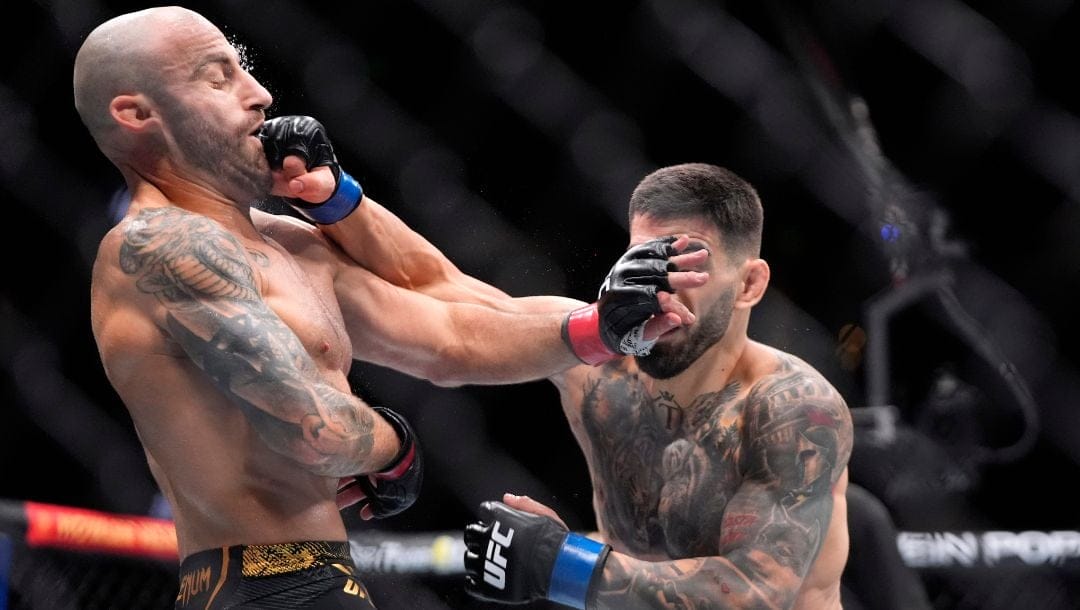 Ilia Topuria, right, connects with Alexander Volanovski during their featherweight bout at the UFC 298 mixed martial arts event.