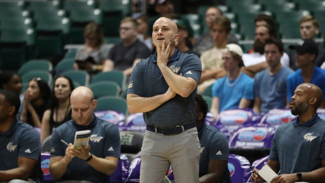 George Washington head coach Chris Caputo stands on the sideline as his team takes on Washington State during the first half of an NCAA college basketball game, Thursday, Dec. 22, 2022, in Honolulu. (AP Photo/Marco Garcia)