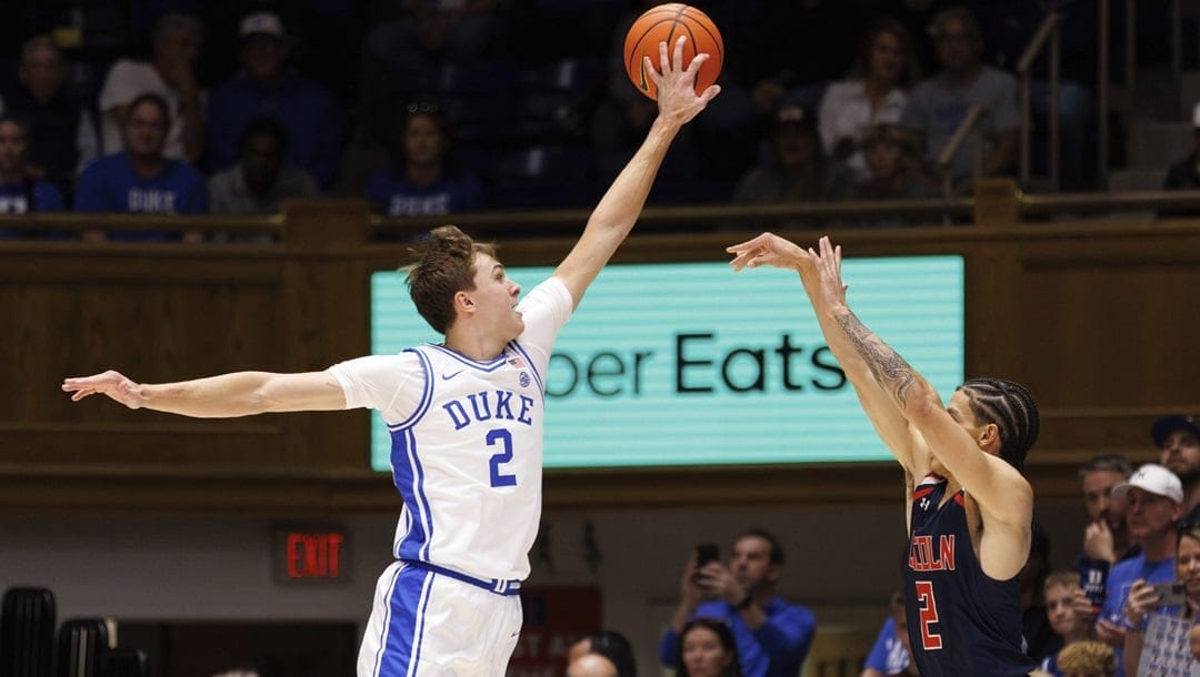 Duke's Cooper Flagg, left, blocks a shot from Lincoln's Freddie Young, right, during the first half of an exhibition NCAA college basketball game in Durham, N.C., Saturday, Oct. 19, 2024.