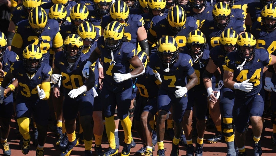 Michigan players run onto the field before an NCAA college football game against Southern California in Ann Arbor, Mich., Saturday, Sept. 21, 2024.