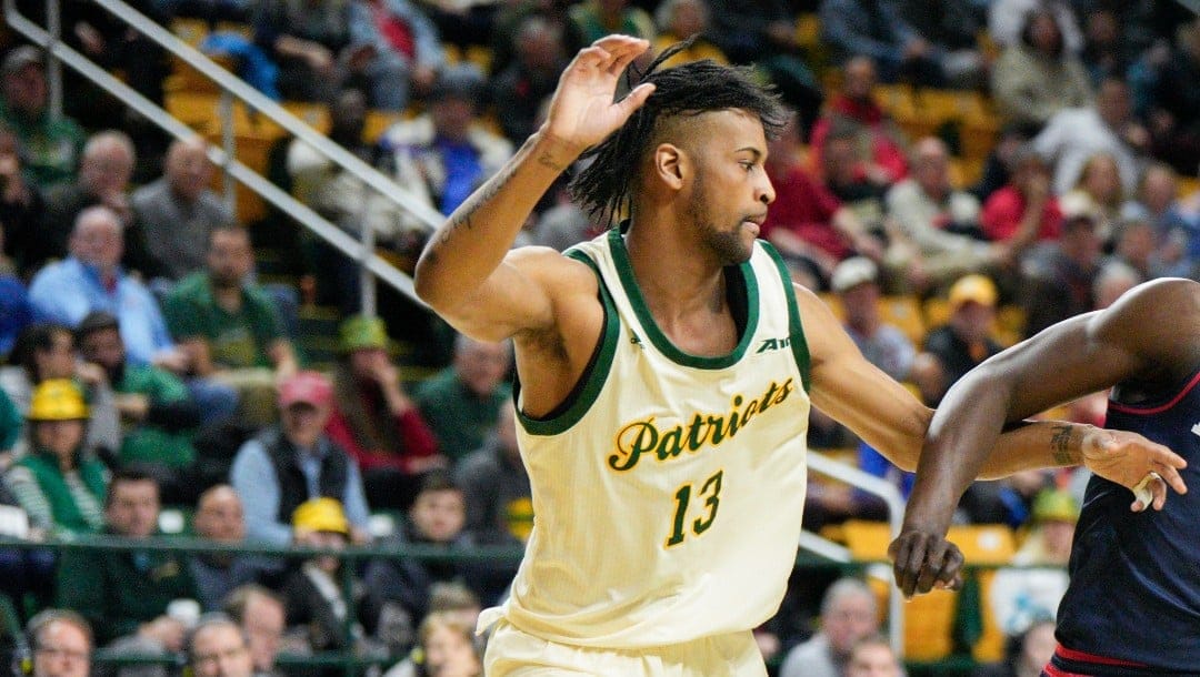 Dayton guard Enoch Cheeks (6) drives to the basket against George Mason guard Darius Maddox (13) during the first half of an NCAA college basketball game, Wednesday, Feb. 21, 2024, in Fairfax, Va. George Mason won 71-67. (AP Photo/Jess Rapfogel)