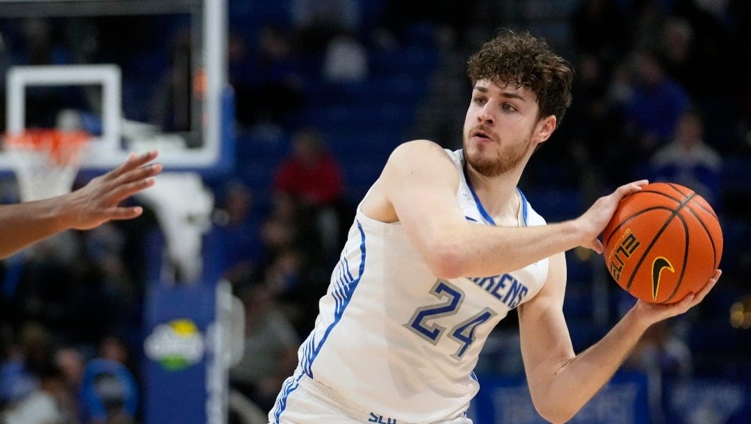 Saint Louis guard Gibson Jimerson (24) looks to pass around Saint Joseph's guard Cameron Brown during the second half of an NCAA college basketball game Wednesday, Jan. 10, 2024, in St. Louis. (AP Photo/Jeff Roberson)