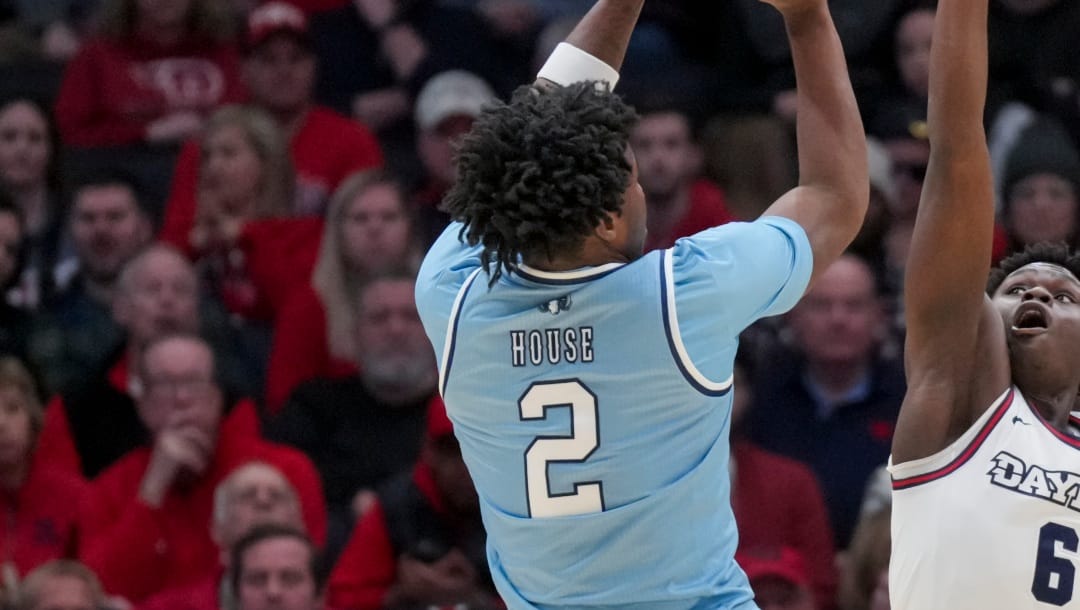 Rhode Island guard Jaden House (2) attempts a 3-point basket over Dayton guard Enoch Cheeks (6) during the first half of an NCAA college basketball game, Saturday, Jan. 20, 2024, in Dayton, Ohio. (AP Photo/Aaron Doster)