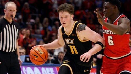 Virginia Commonwealth's Max Shulga (11) dribbles as Dayton's Enoch Cheeks (6) defends during the first half of an NCAA college basketball game Friday, March 8, 2024, in Dayton, Ohio. (AP Photo/Jay LaPrete)