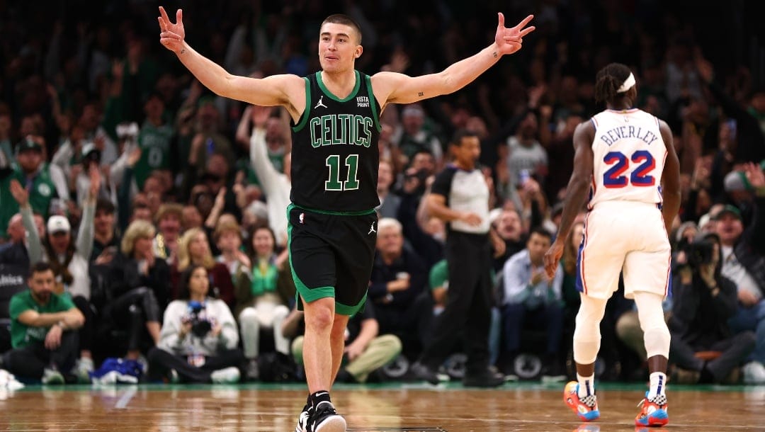 Payton Pritchard #11 of the Boston Celtics celebrates after hitting a three point shot against the Philadelphia 76ers during the second half at TD Garden on December 01, 2023 in Boston, Massachusetts.