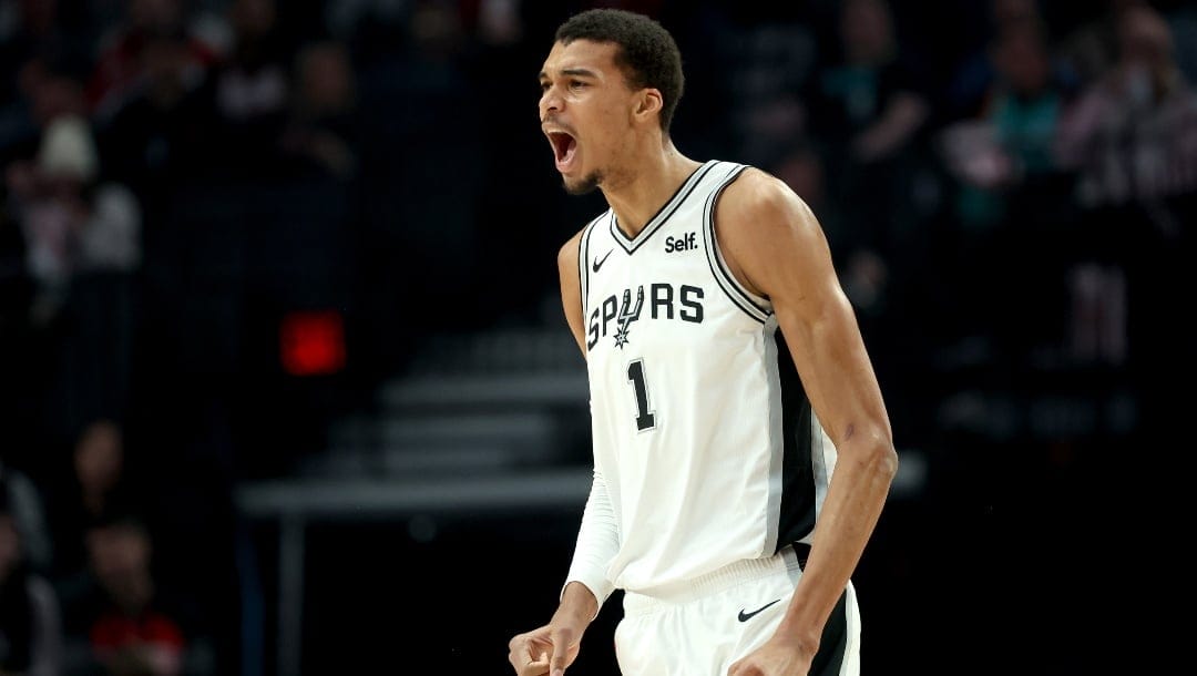 Victor Wembanyama #1 of the San Antonio Spurs reacts during the first quarter against the Portland Trail Blazers at Moda Center on December 28, 2023 in Portland, Oregon.