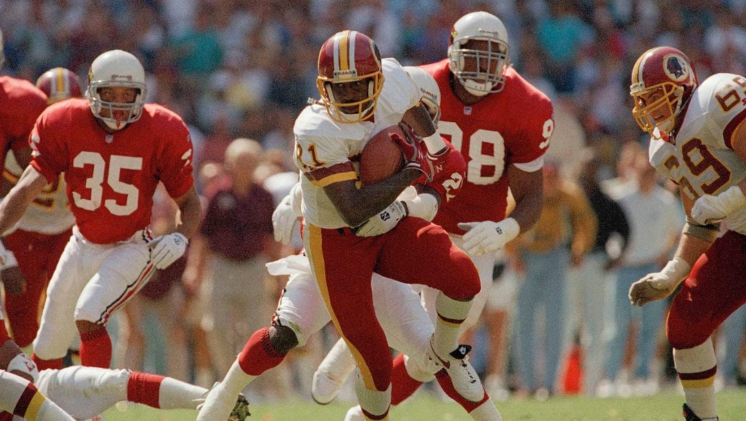 An unidentified Phoenix Cardinals defender tries to stop Washington Redskins wide receiver Art Monk during their game, Sept. 12, 1993 at RFK Stadium in Washington.