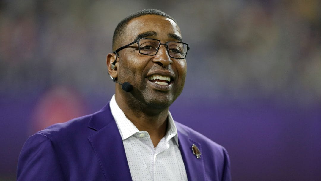 Former Minnesota Vikings wide receiver Cris Carter stands on the field before an NFL football game between the Vikings and the Green Bay Packers, Monday, Dec. 23, 2019, in Minneapolis.