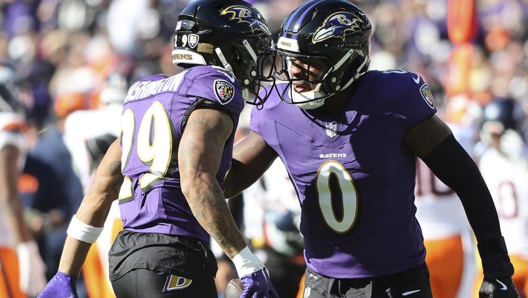 Baltimore Ravens safety Ar'Darius Washington (29) celebrates with Baltimore Ravens linebacker Roquan Smith (0) during an NFL football game against the Denver Broncos, Sunday, November 3, 2024 in Baltimore.