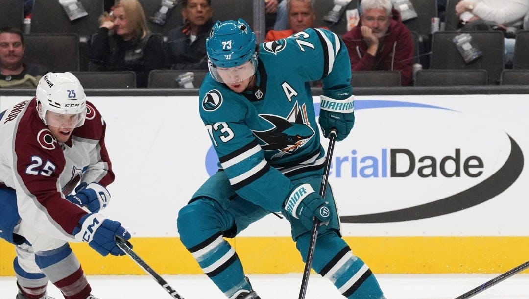 Colorado Avalanche's Logan O'Connor (25), left, and teammate Nikolai Kovalenko (51), right, fight for the puck against San Jose Sharks center Tyler Toffoli (73) during the first period of an NHL hockey game in San Jose, Calif., Sunday, Oct. 20, 2024. (AP Photo/Minh Connors)