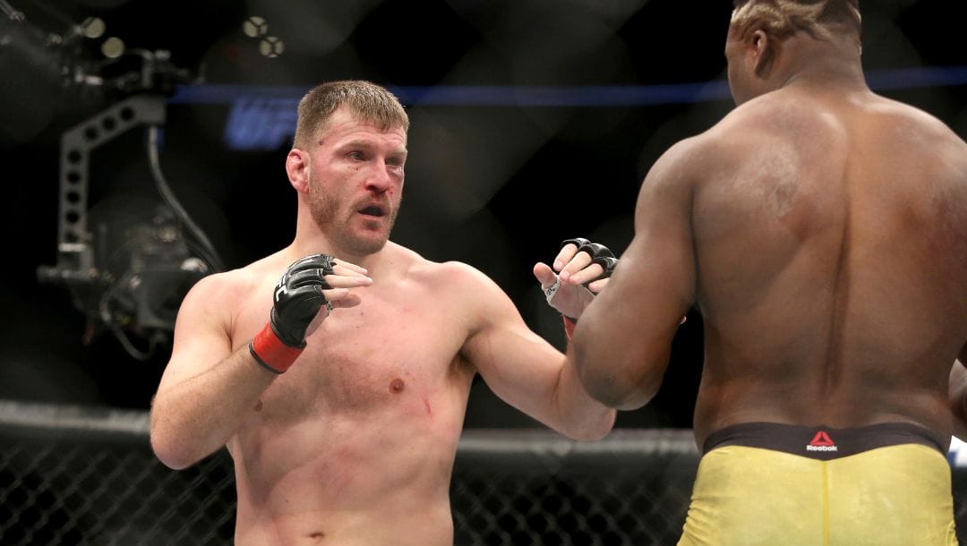 Stipe Miocic in action against Francis Ngannou during a heavyweight championship mixed martial arts bout at UFC 220.