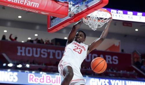 Houston guard Terrance Arceneaux (23) hangs on the rim after his slam dunk against Butler during the second half of an NCAA college basketball game Saturday, Dec. 7, 2024, in Houston. (AP Photo/Michael Wyke)