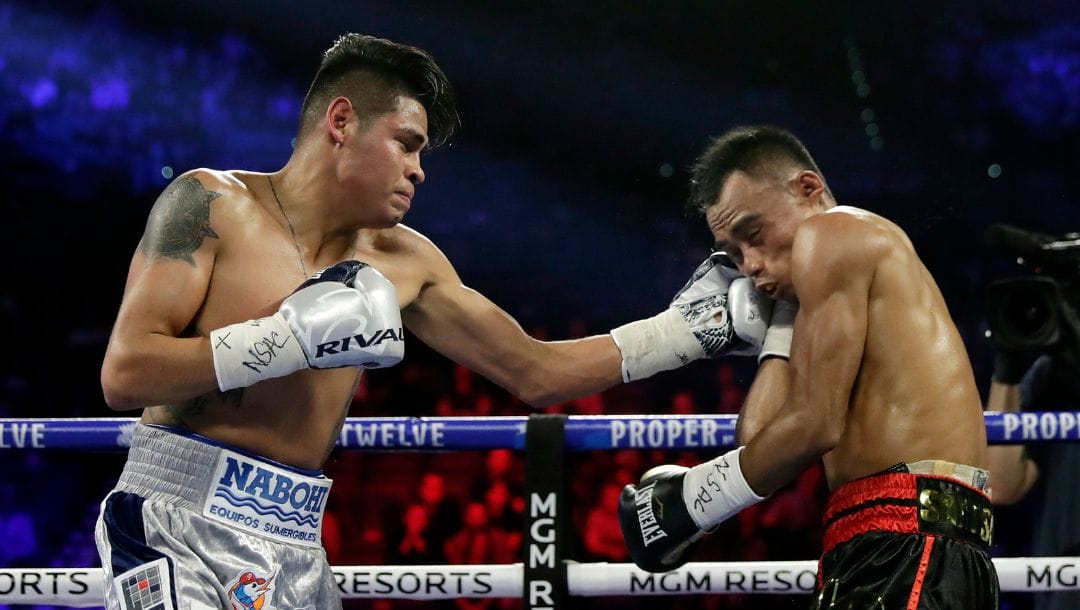 Emanuel Navarrete, left, of Mexico, punches Jeo Santisima, of the Philippines, during their super bantamweight boxing match.