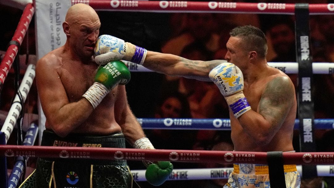 Britain's Tyson Fury, left, and Ukraine's Oleksandr Usyk trade blows during their undisputed heavyweight world championship.