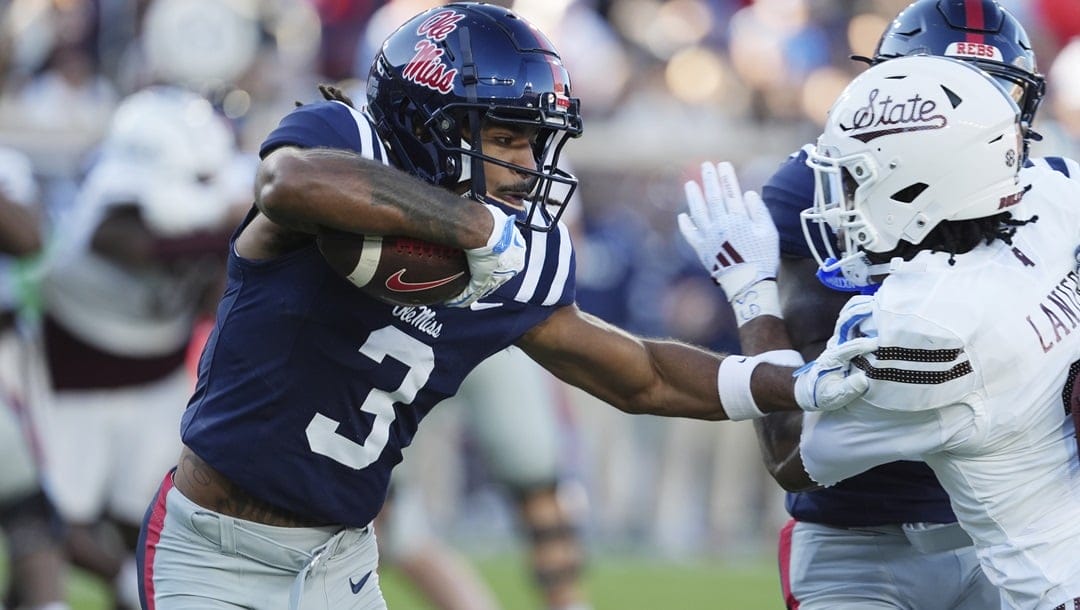 Mississippi wide receiver Antwane Wells Jr. (3) reaches out to ward off Mississippi State safety Brylan Lanier (3) during the first half of an NCAA college football game, Friday, Nov. 29, 2024, in Oxford, Miss. Mississippi won 26-14.